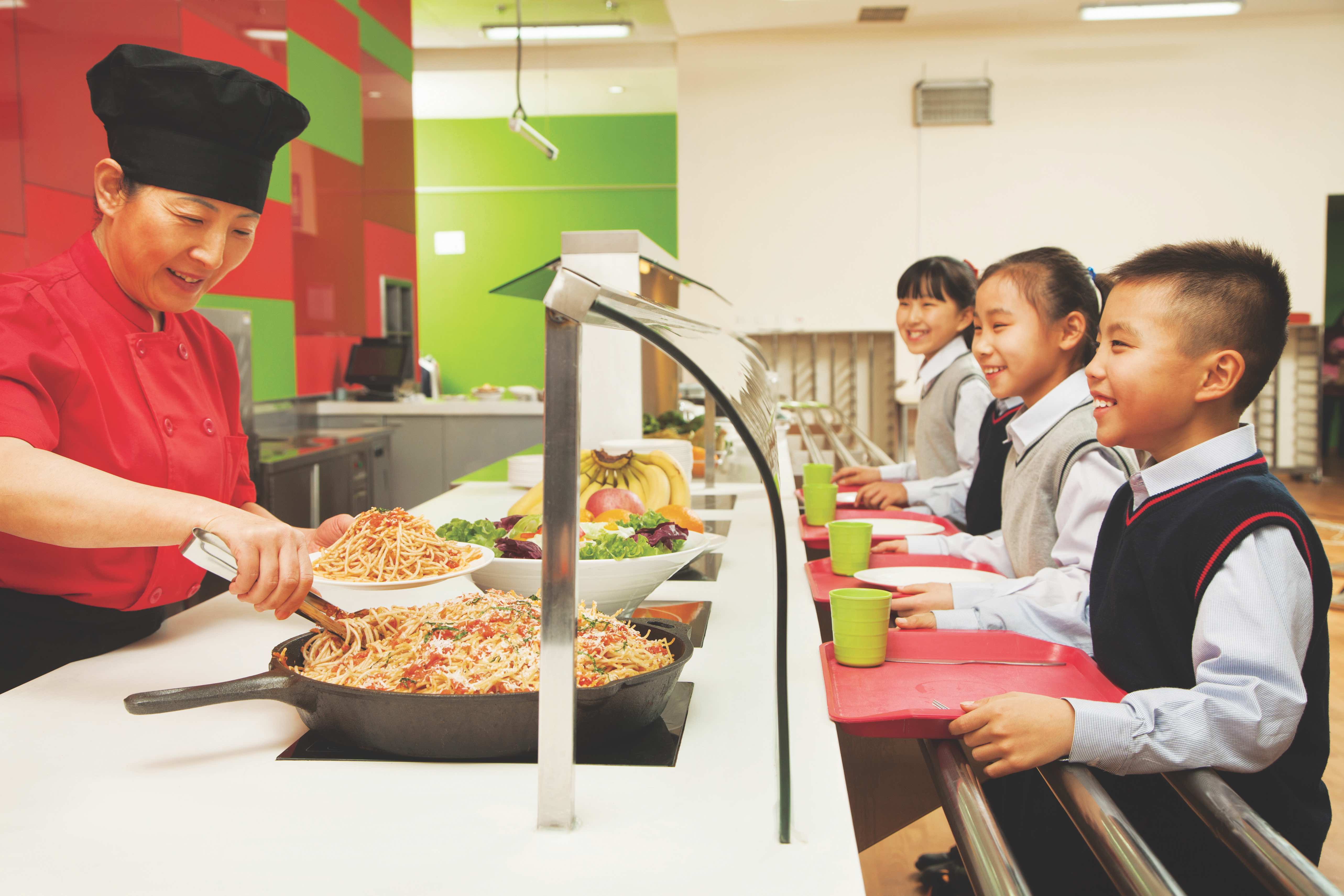 School children standing in line in school cafeteria